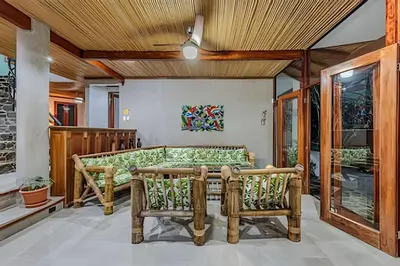 a room with a bed and two chairs at The Jungle Inn in Dominicalito