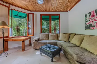 a living room with a couch and a table at The Jungle Inn in Dominicalito