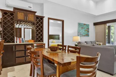 a kitchen and dining room with a wooden table and chairs at Roca Blanca -Private Pool- Near To Conchal & Flamingo Beach in Brasilito