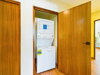 a washer and dryer in a room with a door at Casa Mariposa - villa with infinity pool, near beach in Brasilito