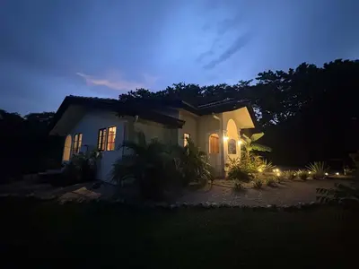 a small white house at night with lights at Casa Mariposa - villa with infinity pool, near beach in Brasilito
