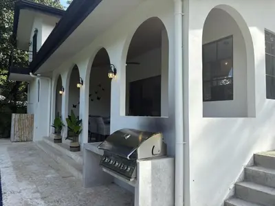 an outdoor grill on the side of a house at Casa Mariposa - villa with infinity pool, near beach in Brasilito
