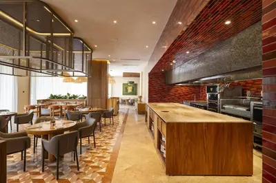 a restaurant with tables and chairs in a room at Waldorf Astoria Costa Rica Punta Cacique in Playa Hermosa