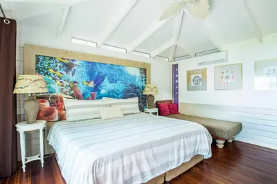 a bedroom with a bed and a painting on the wall at Dream On Costa Rica in Santa Cruz