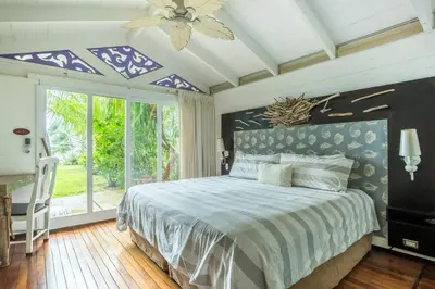 a bedroom with a bed and a ceiling fan at Dream On Costa Rica in Santa Cruz