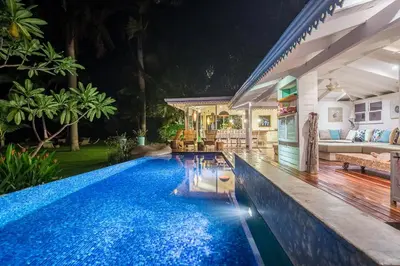 a swimming pool in front of a house at night at Dream On Costa Rica in Santa Cruz