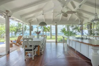 a dining room with a table and a view of the ocean at Dream On Costa Rica in Santa Cruz