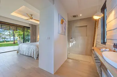 a bathroom with a bed and a shower and a sink at Dream On Costa Rica in Santa Cruz