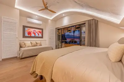 a bedroom with a large bed and a couch at Dream On Costa Rica in Santa Cruz