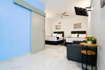 a living room with two beds and a couch at Apartaestudios la capital in San José