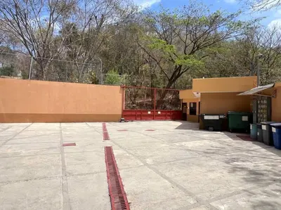 an empty parking lot in front of a building at Breathtaking Ocean View Condo in Sámara
