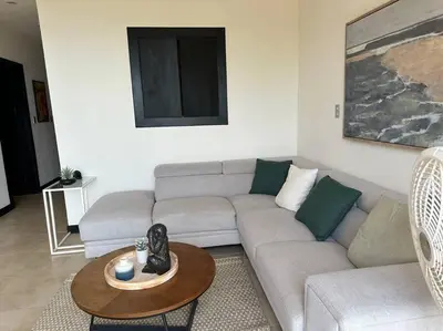 a living room with a couch and a table at Breathtaking Ocean View Condo in Sámara