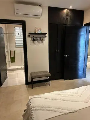 a bedroom with a bed and a black closet at Breathtaking Ocean View Condo in Sámara