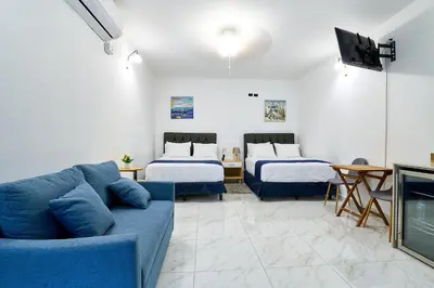 a living room with two beds and a couch at Apartaestudio la capital in San José