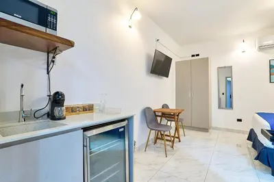 a kitchen with a sink and a table in a room at #5 Apartaestudio la capital in San José