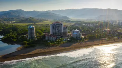 an aerial view of a city on the beach at The Palms Ocean Club Resort in Jacó