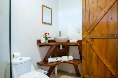 a bathroom with a sink and a toilet at Tierra Buena Countryside Hotel in Monteverde Costa Rica