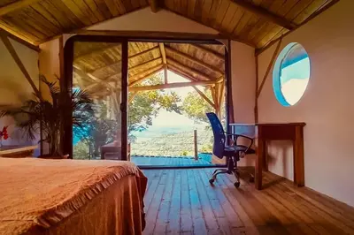 a bedroom with a bed and a desk and a window at Sundancefamily Paradise Villa in Sámara