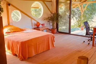 a bedroom with an orange bed and a large window at Sundancefamily Paradise Villa in Sámara