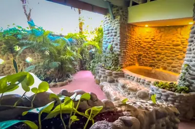 a garden with a bathtub in a stone wall at Sundancefamily Paradise Villa in Sámara