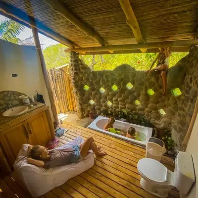 a man laying on a bed in a bathroom with a tub at Sundancefamily Paradise Villa in Sámara