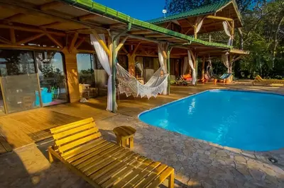 a swimming pool with a bench next to a house at Sundancefamily Paradise Villa in Sámara
