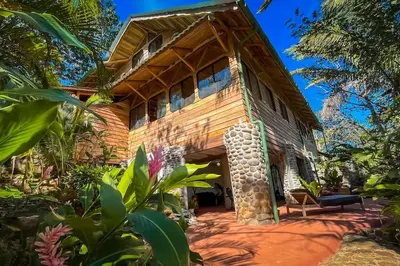 an exterior view of a house in the jungle at Sundancefamily Paradise Villa in Sámara