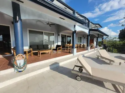 a house with a patio with a plane on it at Luxury Villa with Separate Guest house and 360view in Quepos