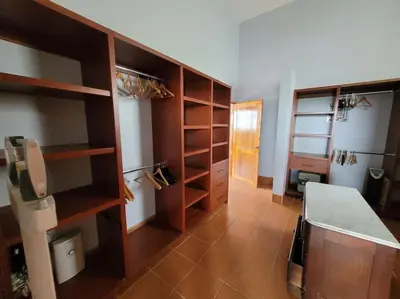 a large room with wooden shelves and a kitchen at Luxury Villa with Separate Guest house and 360view in Quepos