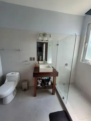 a bathroom with a sink and a toilet at Luxury Villa with Separate Guest house and 360view in Quepos