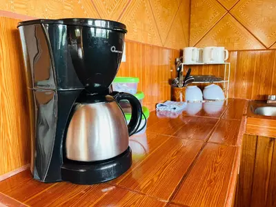 a coffee maker sitting on a wooden counter top at Los Tucanes Lodging in El Castillo de La Fortuna
