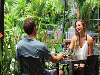 a man and a woman sitting at a table at Oceano Boutique Hotel & Bistró in Jacó