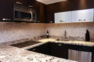 a kitchen with a sink and a microwave at Oceano Boutique Hotel & Bistró in Jacó