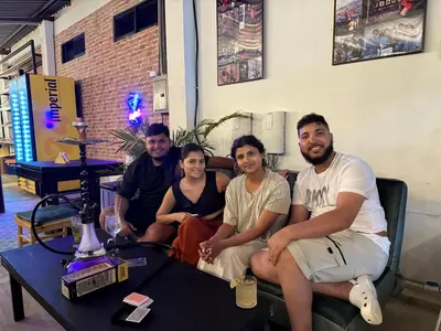 a group of people sitting on a couch at Asha Hostel in Fortuna