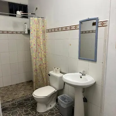 a bathroom with a toilet and a sink at Asha Hostel in Fortuna