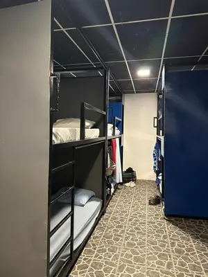 a room with two bunk beds in a room with a floor at Asha Hostel in Fortuna