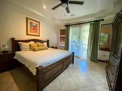 a bedroom with a bed and a ceiling fan at Espacioso Condominio en Pacific Sun in Jacó