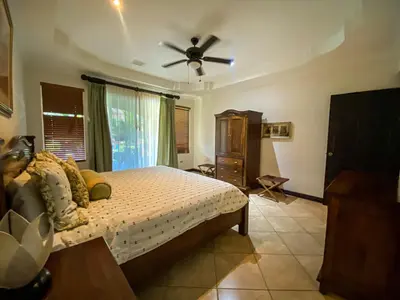 a bedroom with a bed and a ceiling fan at Espacioso Condominio en Pacific Sun in Jacó