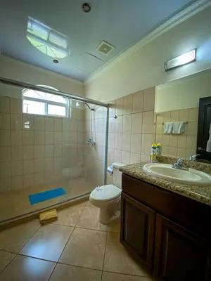 a bathroom with a shower and a toilet and a sink at Espacioso Condominio en Pacific Sun in Jacó
