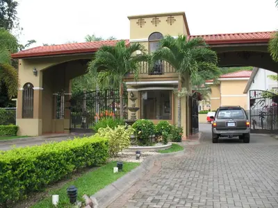 a car is parked in front of a house at Espacioso Condominio en Pacific Sun in Jacó