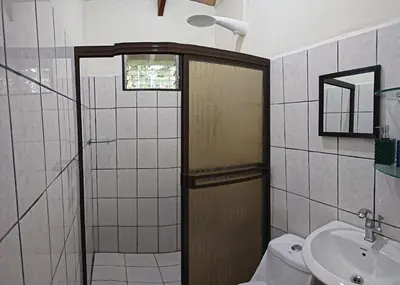 a bathroom with a shower and a toilet and a sink at Casa Arthémis - Rainforest Lodge in Guápiles