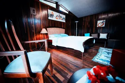 a bedroom with a bed and a table and chairs at Rainforest Cabin in Escazu in Escazu