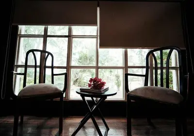 two chairs and a table in front of a window at Rainforest Cabin in Escazu in Escazu