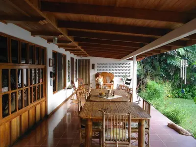 a porch with a wooden table and chairs at Quinta Don Fernando in La Garita