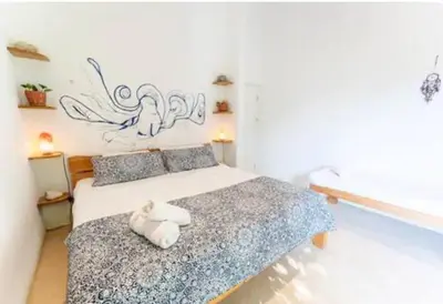 a bedroom with a bed with two towels on it at Kai Villa in Santa Teresa Beach