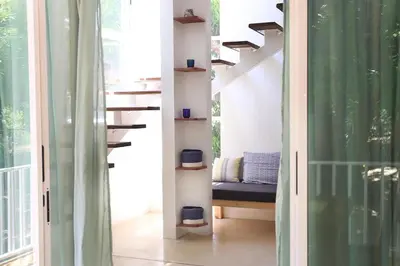 a room with a staircase with a bench in a room at Kai Villa in Santa Teresa Beach