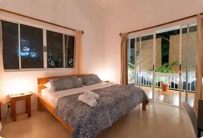 a bedroom with a bed with a white towel on it at Kai Villa in Santa Teresa Beach