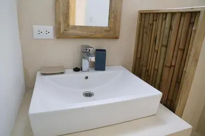 a white sink in a bathroom with a mirror at Kai Villa in Santa Teresa Beach
