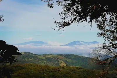 a view of a mountain with clouds in the distance at Rainbow House in Monteverde Costa Rica