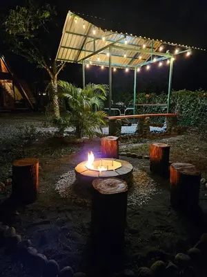 a fire pit in a garden at night with lights at Betulio's Oasis in Fortuna
